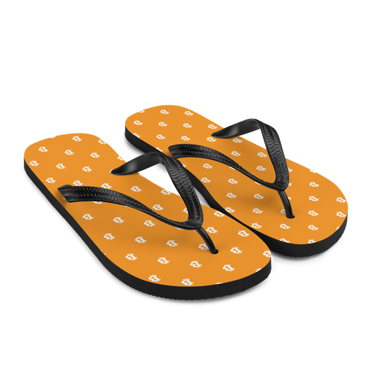 Side view of a pair of orange bitcoin flip flops.