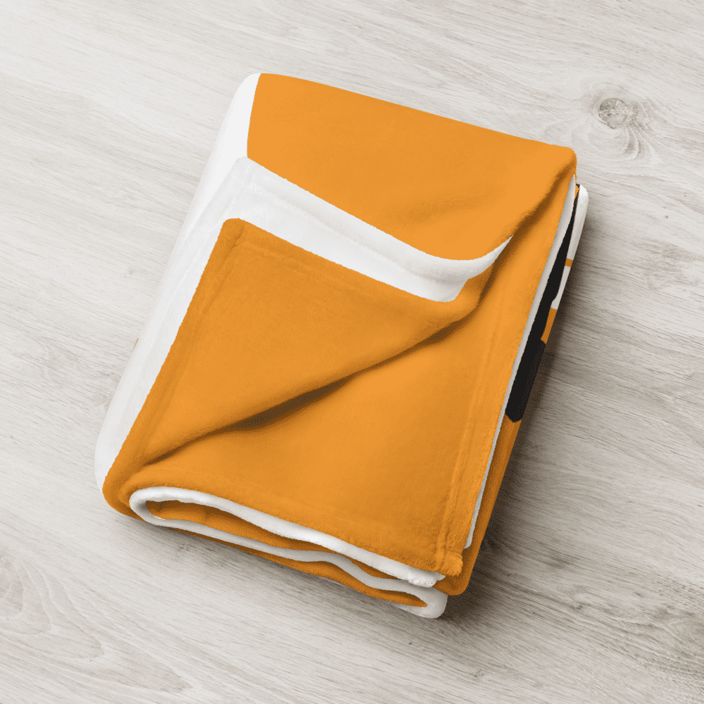 Detailed view of the folded orange bitcoin blanket.