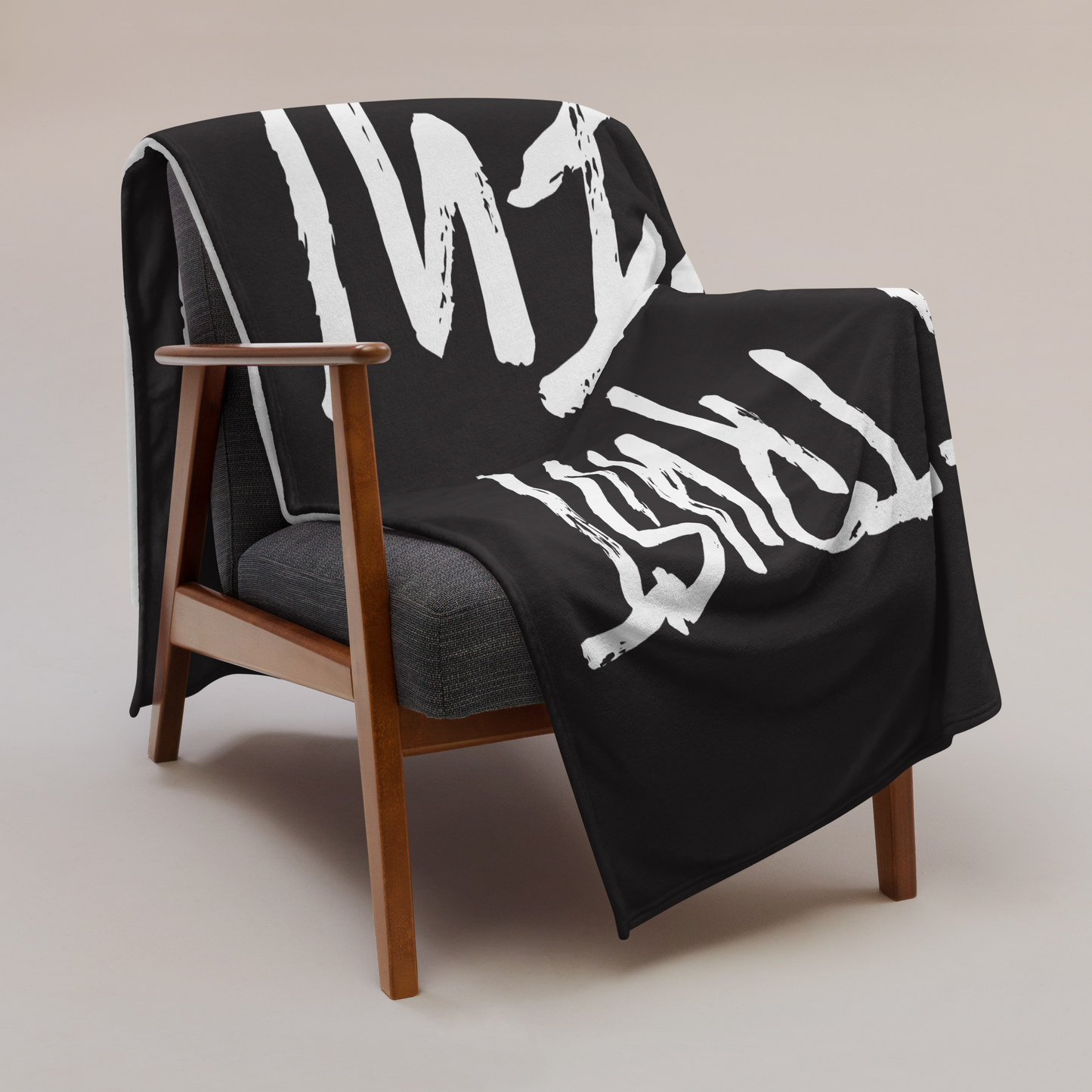 View of a chair with a black bitcoin blanket.