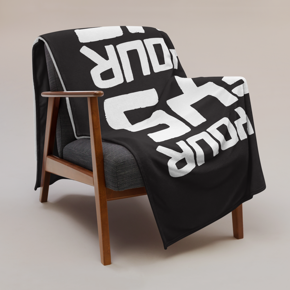 View of a sofa with a black bitcoin blanket.