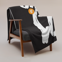 21 Million Bitcoin throw blanket draped over a wooden armchair, showing the design across the full width of the blanket.
