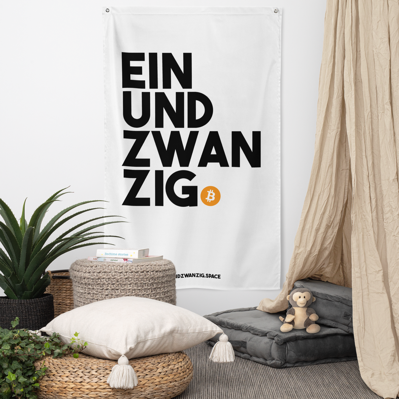 Einundzwanzig bitcoin flag, hanging on a wall above a seating corner.