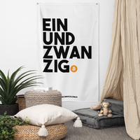 Einundzwanzig bitcoin flag, hanging on a wall above a seating corner.