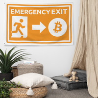 Emergency Exit bitcoin flag, hanging on a wall above a seating corner.