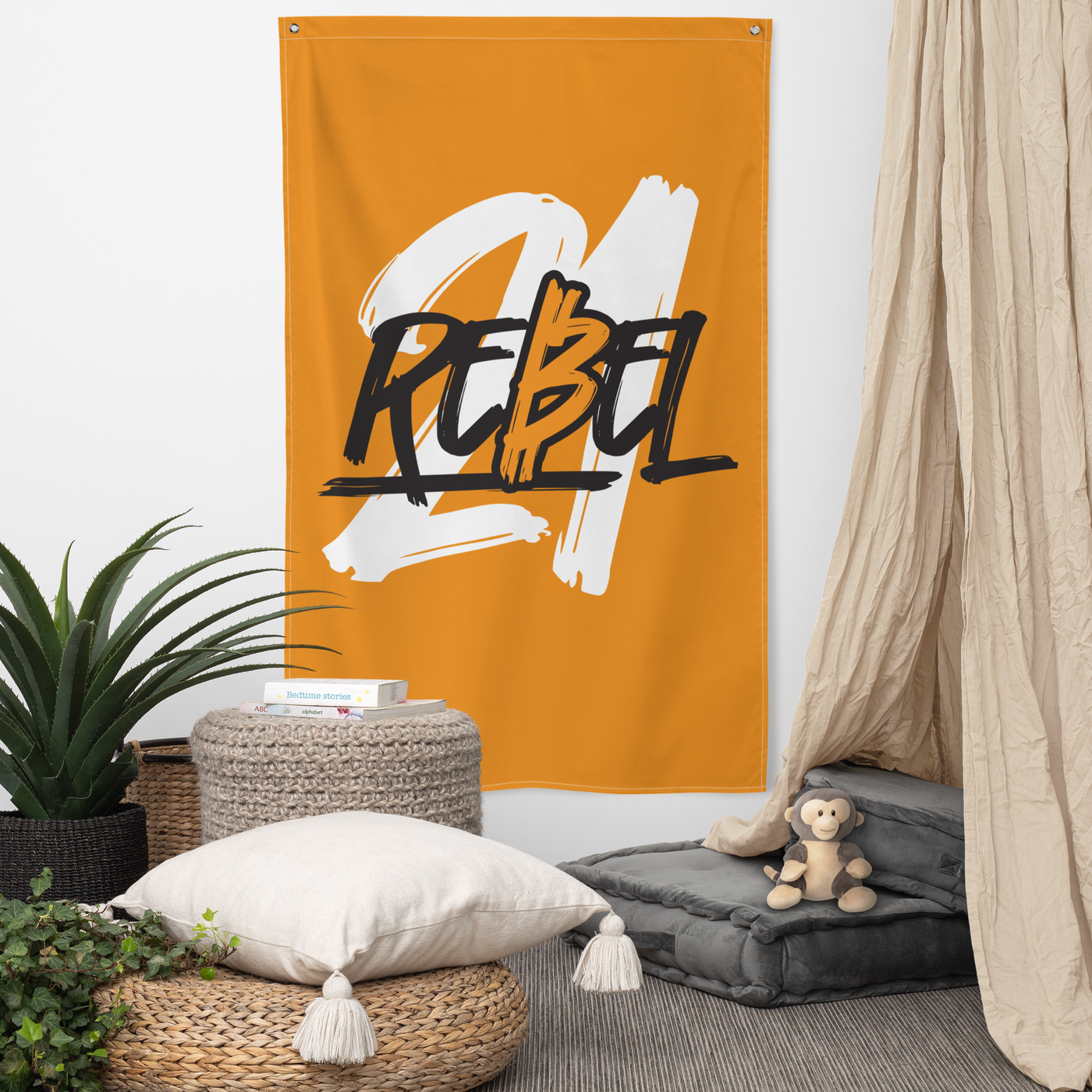 21 Rebel bitcoin flag, hanging on a wall above a seating corner.