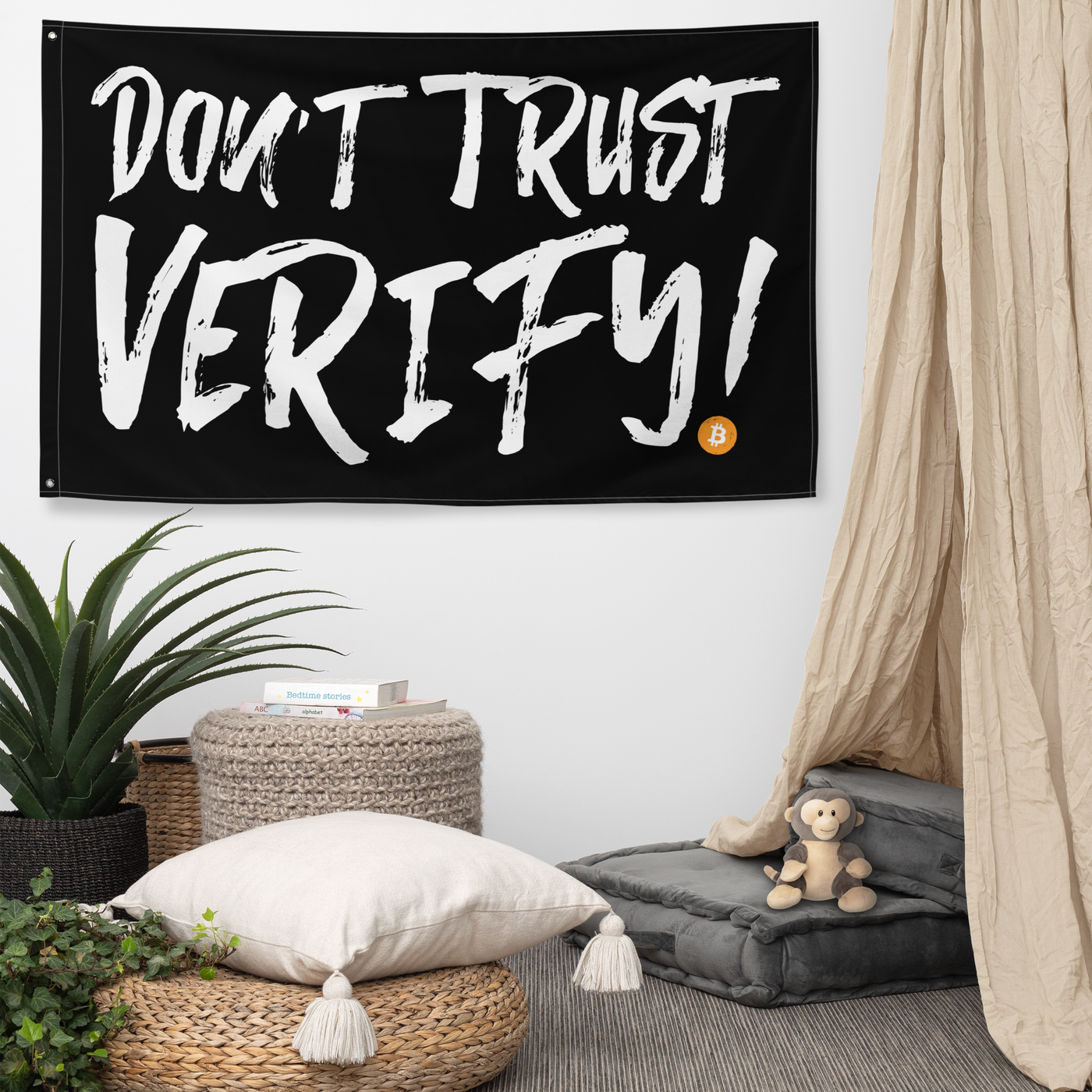 Don't Trust Verify! bitcoin flag, hanging on a wall above a seating corner.