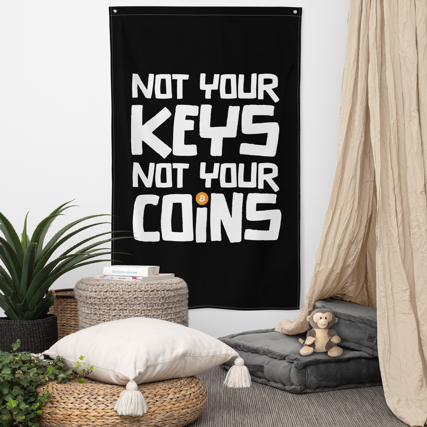 Not your Keys Not your Coins bitcoin flag, hanging on a wall above a seating corner.