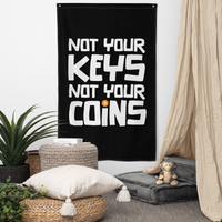 Not your Keys Not your Coins bitcoin flag, hanging on a wall above a seating corner.