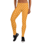 Front view of a woman wearing orange bitcoin leggings.