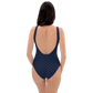 Back view of a woman wearing a navy blue bitcoin swimsuit.