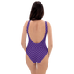 Back view of a woman wearing a purple nostr swimsuit.