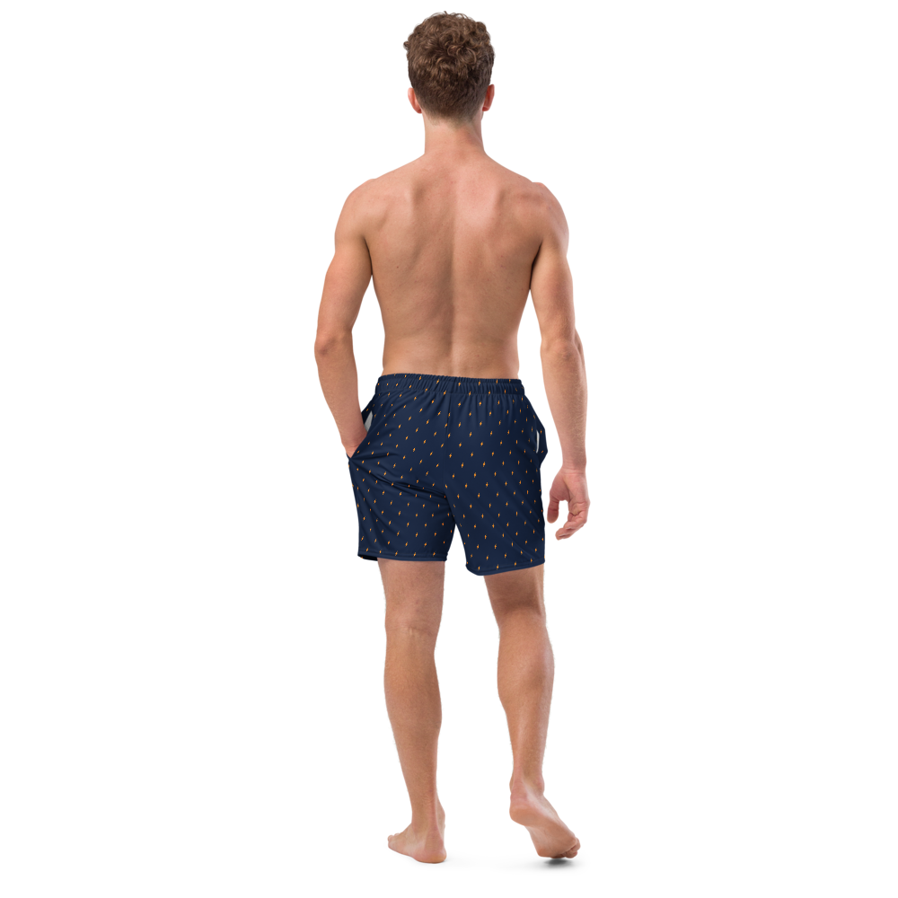 Back view of a man wearing a navy blue bitcoin swim trunks.