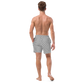 Back view of a man wearing a silver bitcoin swim trunks.