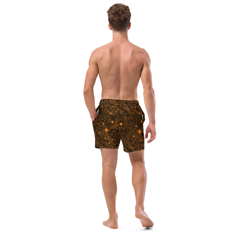 Back view of a man wearing a black bitcoin swim trunks.