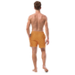 Back view of a man wearing an orange bitcoin swim trunks.