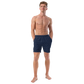 Front view of a man wearing a navy blue bitcoin swim trunks.