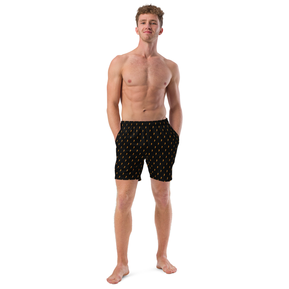 Front view of a man wearing a black bitcoin swim trunks.