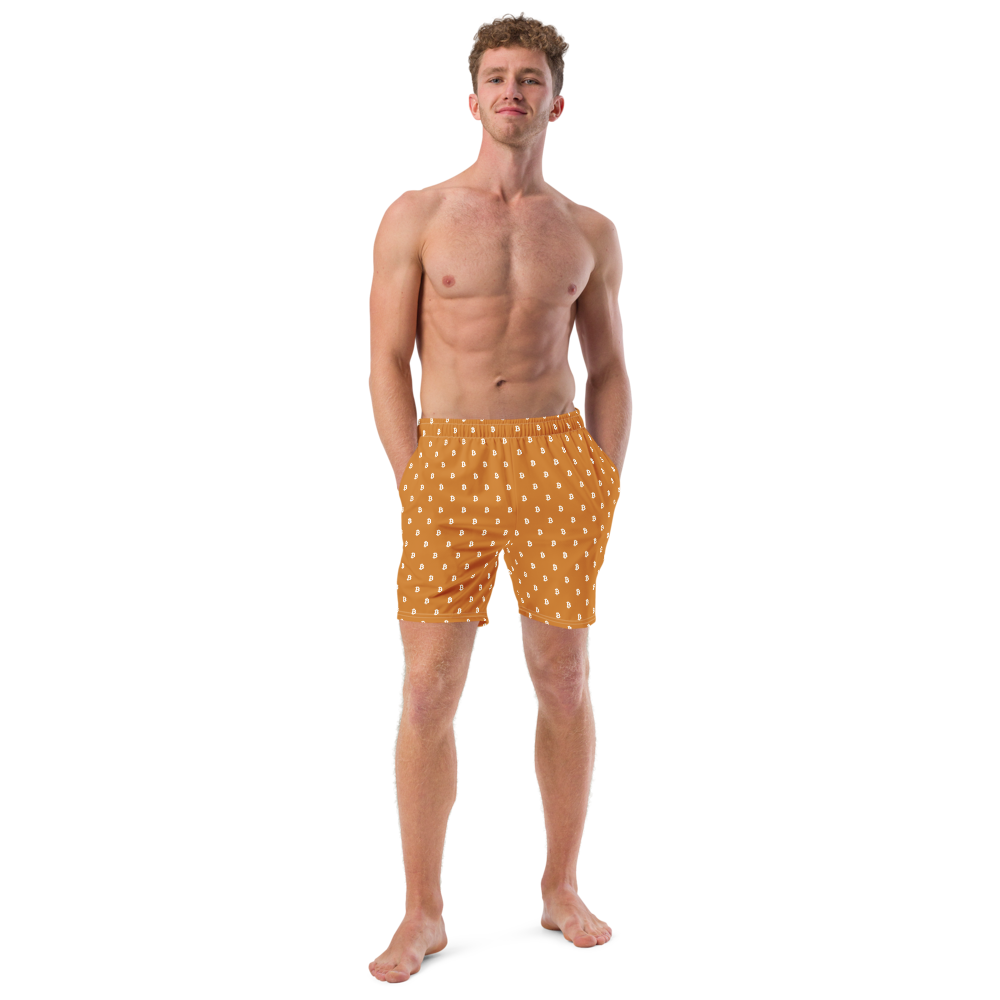 Front view of a man wearing an orange bitcoin swim trunks.