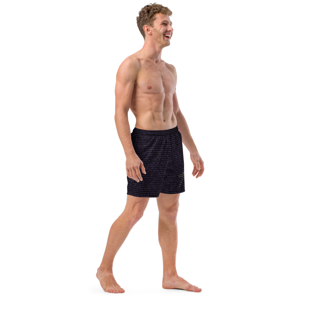 Side view of a man wearing a black nostr swim trunks.