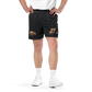 Front view of a man wearing black bitcoin mesh shorts.