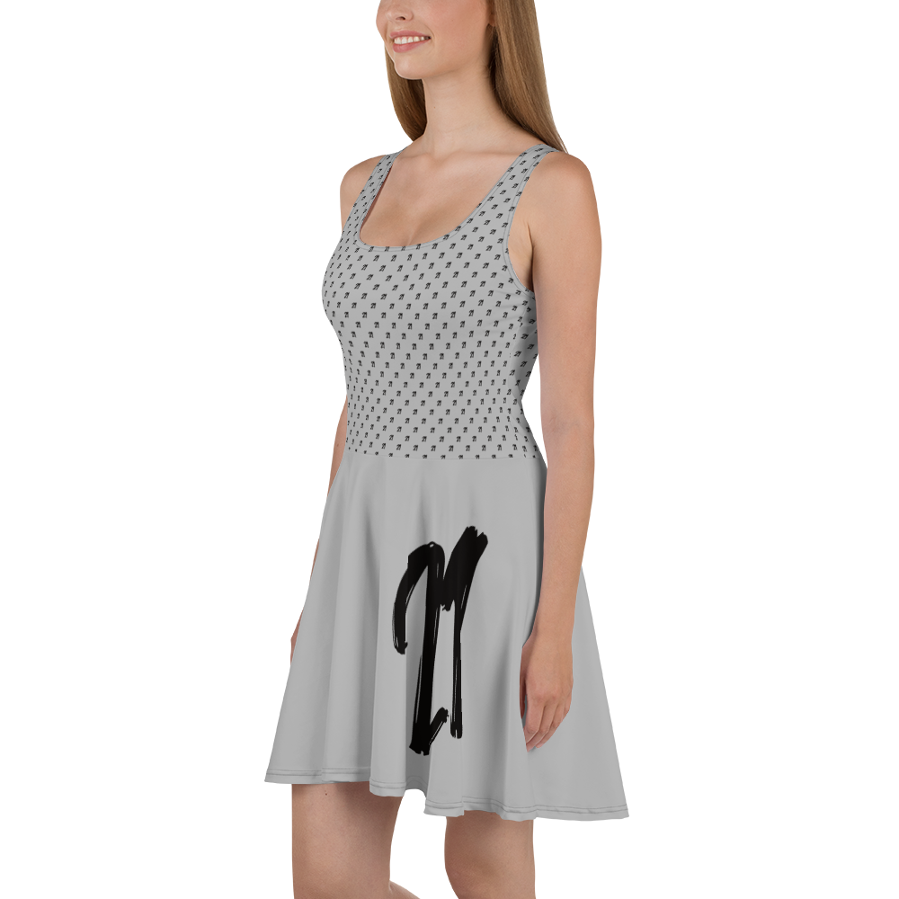 Side view of a woman wearing a silver bitcoin skater dress.