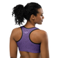 Back view of a woman wearing a purple nostr sports bra.