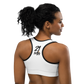 Back view of a woman wearing a white bitcoin sports bra.