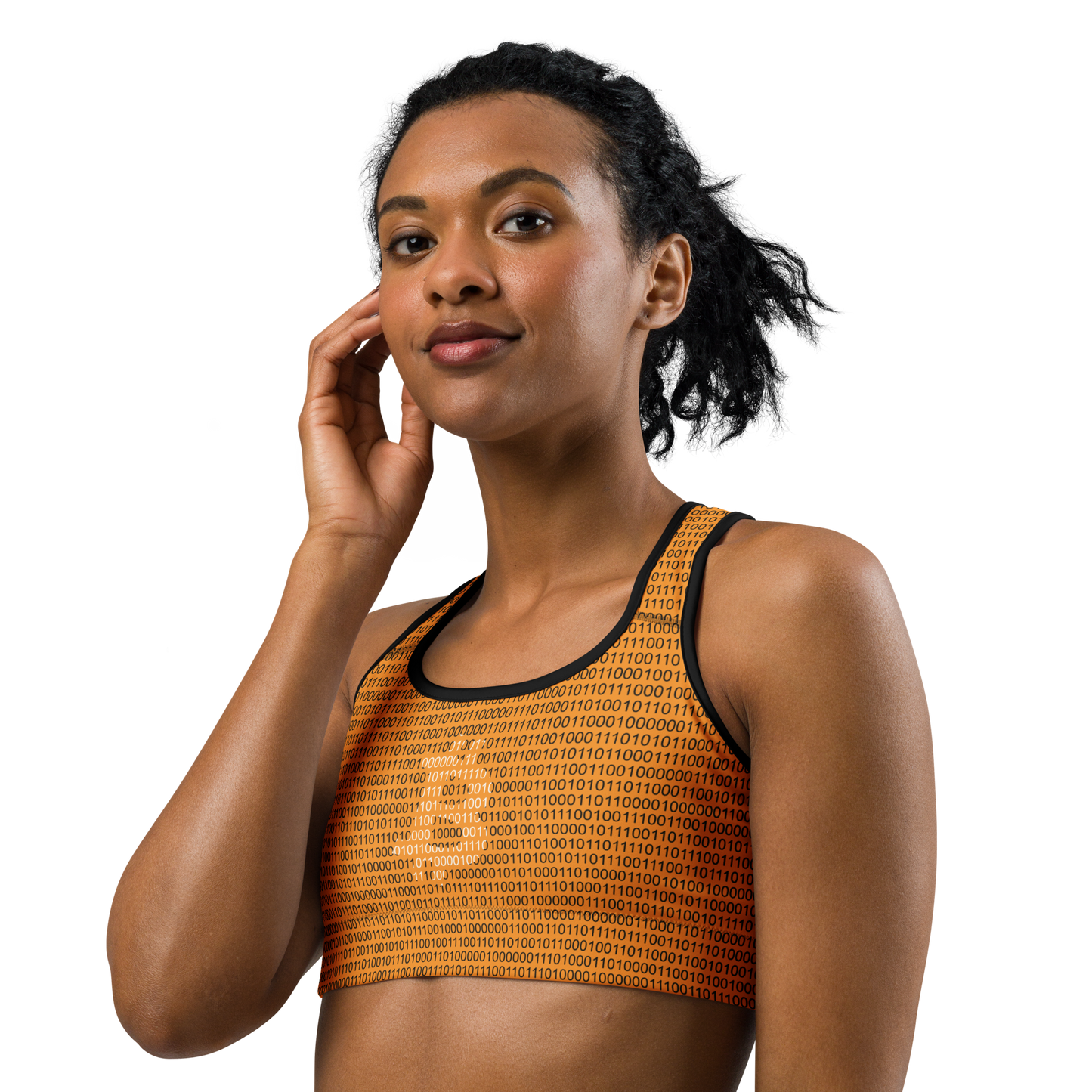 Front view of a woman wearing an orange bitcoin sports bra.