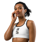 Front view of a woman wearing a white bitcoin sports bra.