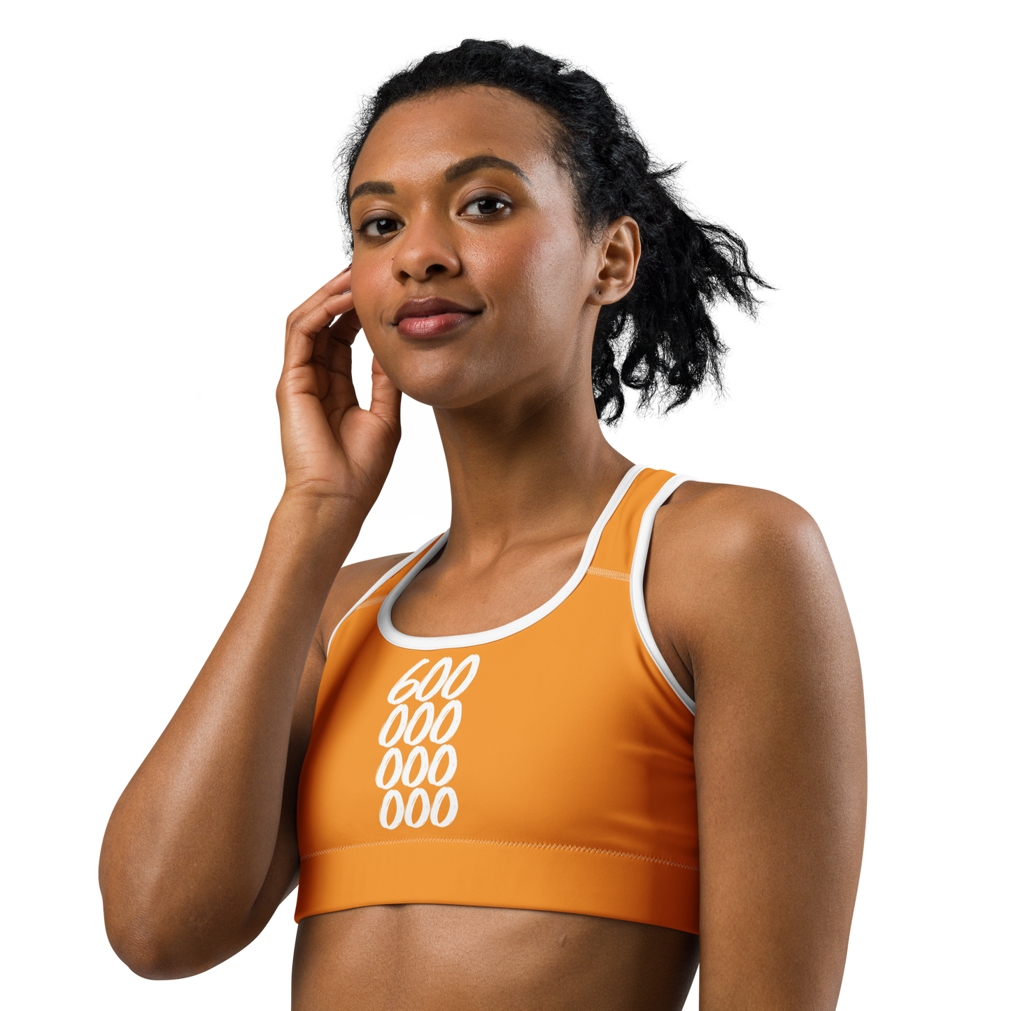 Front view of a woman wearing an orange bitcoin sports bra.