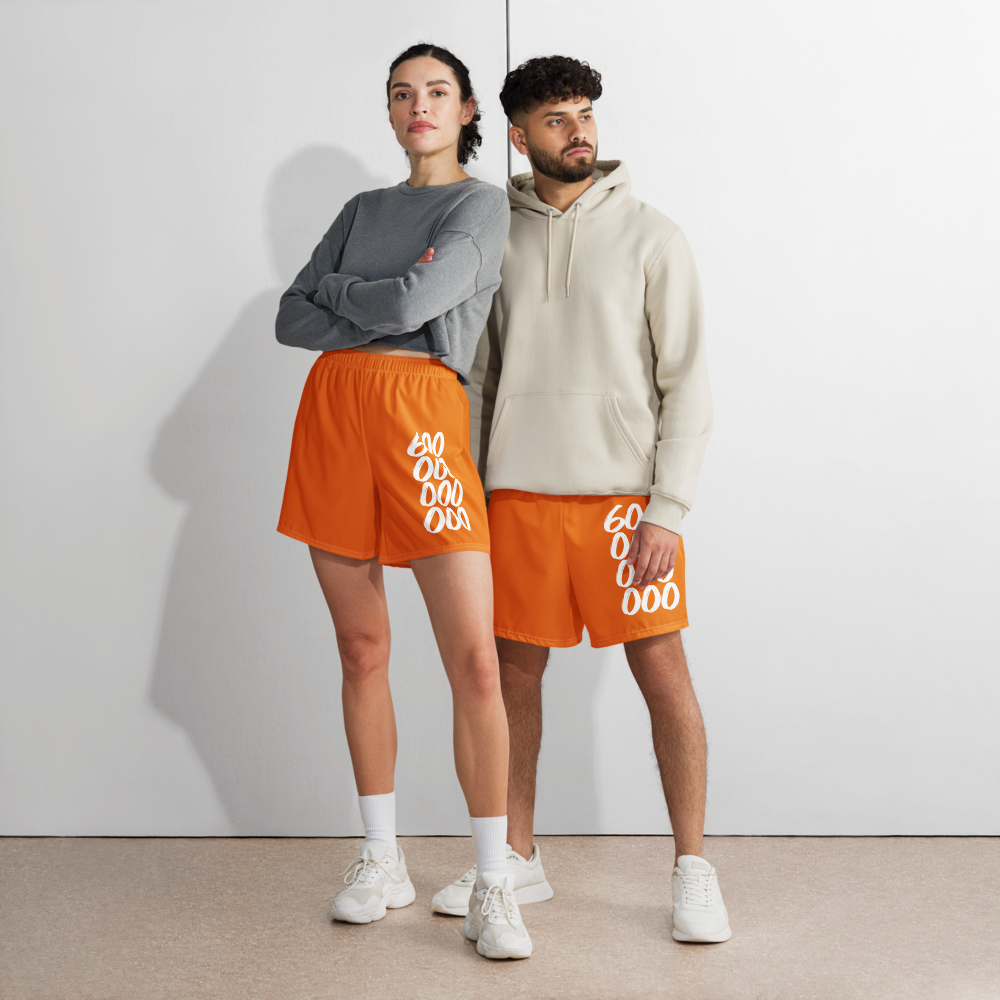 Front view of a man and a woman wearing orange bitcoin athletic shorts.