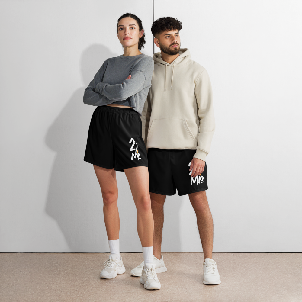 Front view of a man and a woman wearing black bitcoin athletic shorts.