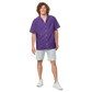 Front view of a man wearing a purple nostr button shirt.