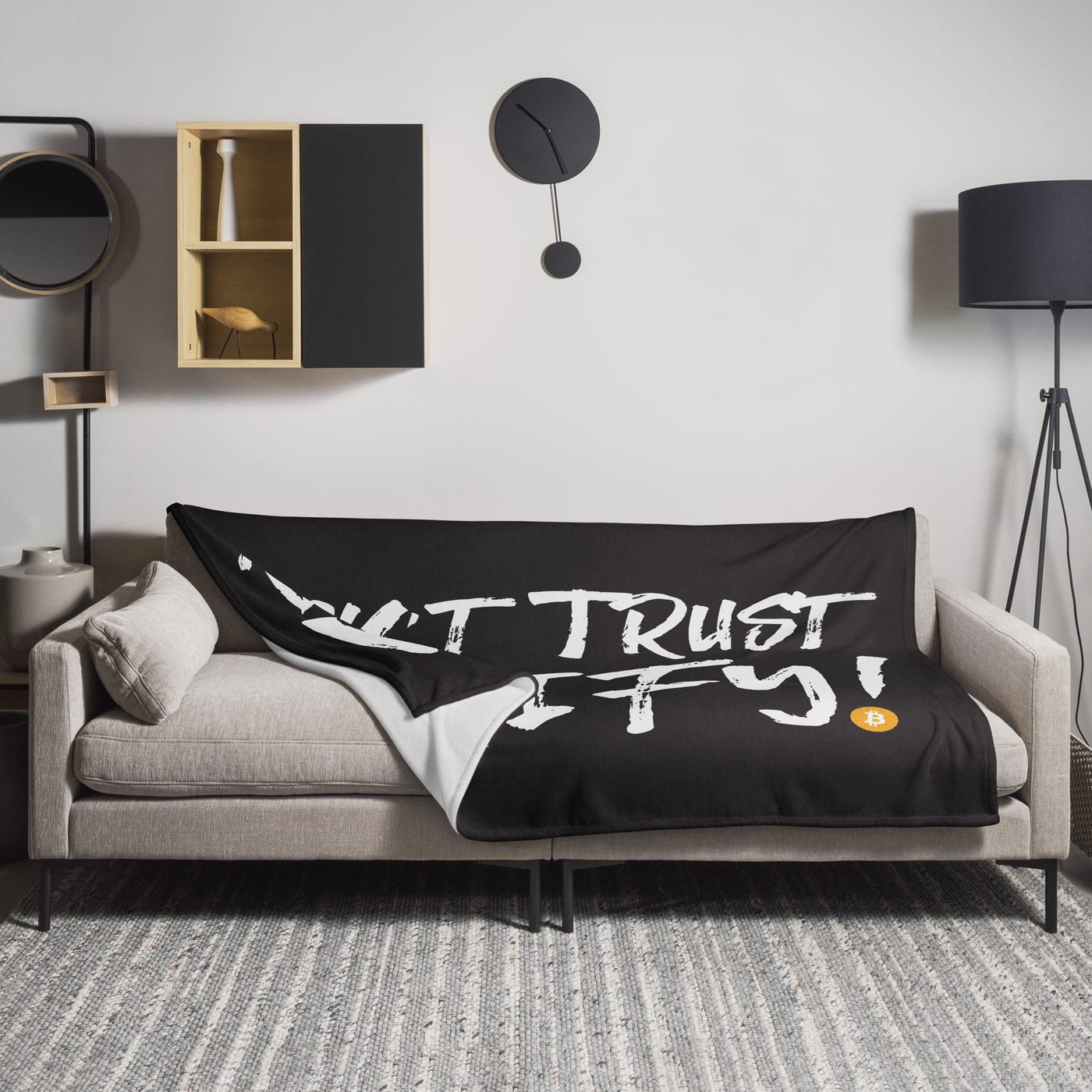 Don't Trust Verify! Bitcoin throw blanket spread across a light grey sofa in a living room, showing the design in a home setting.