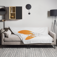 F*** Fiat Money Bitcoin throw blanket spread across a light grey sofa in a living room, showing the design in a home setting.