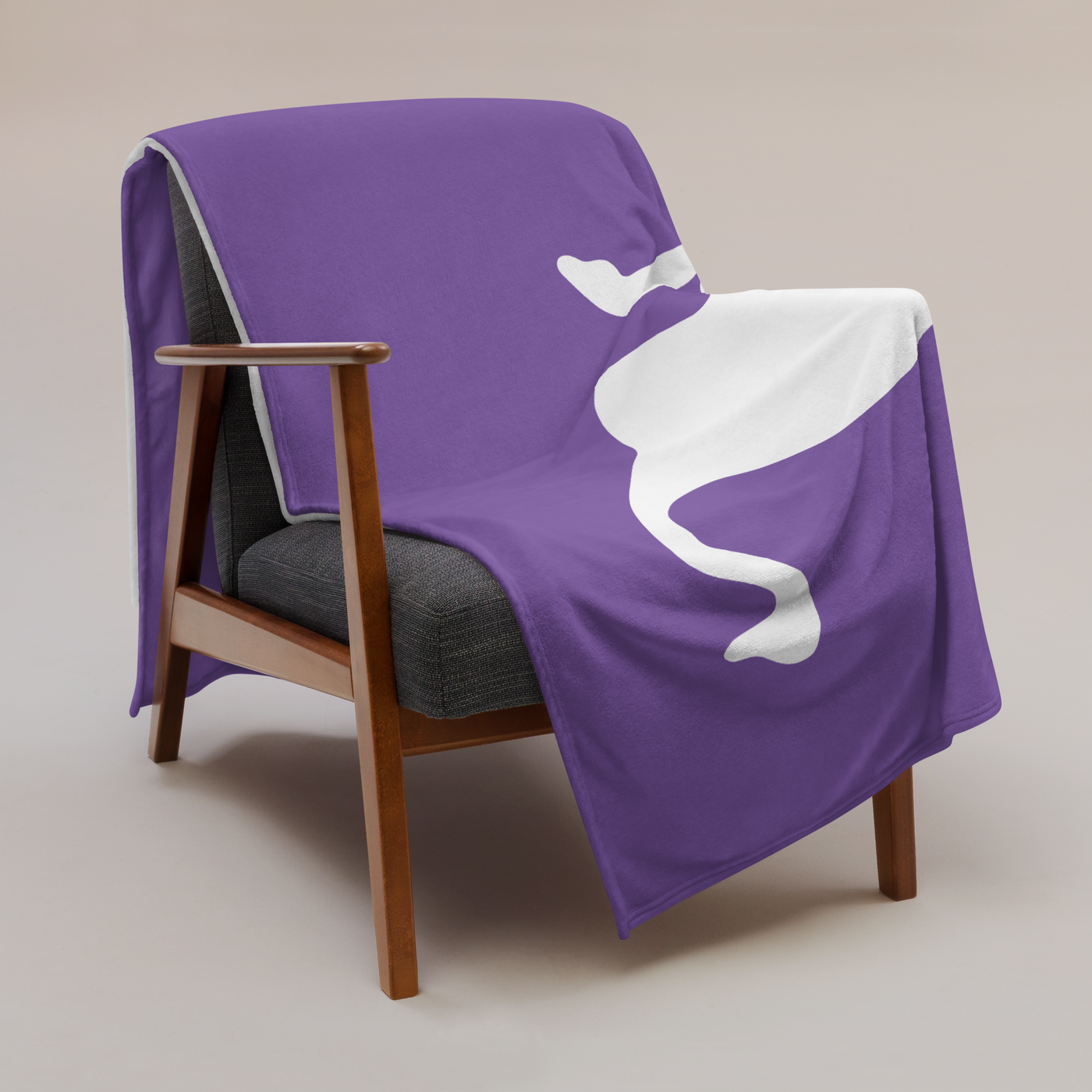 Nostr Nostr throw blanket draped over a wooden armchair, showing the design across the full width of the blanket.
