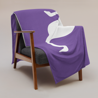 Nostrich Nostr throw blanket draped over a wooden armchair, showing the design across the full width of the blanket.