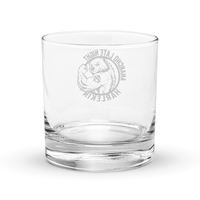 Anarcho Late Night Harlekin rocks glass, clear 10.5 oz whiskey glass with a round badge showing a grinning bear flexing its arm, an anarchy A on the biceps, the words ANARCHO LATE NIGHT arched above and HARLEKIN below, back view, the badge showing through the glass in mirror image.