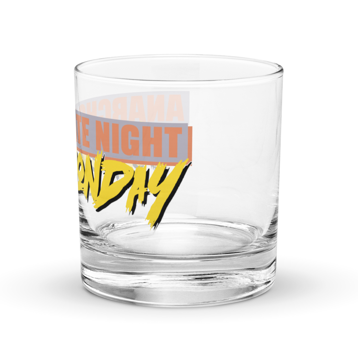 Michael Monday Anarcho Late Night rocks glass, clear 10.5 oz whiskey glass with a band running all the way around: ANARCHO LATE NIGHT in orange on grey above the name Michael Monday in yellow brush script, left side view showing LATE NIGHT and the end of the name.
