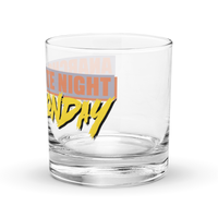 Michael Monday Anarcho Late Night rocks glass, clear 10.5 oz whiskey glass with a band running all the way around: ANARCHO LATE NIGHT in orange on grey above the name Michael Monday in yellow brush script, left side view showing LATE NIGHT and the end of the name.