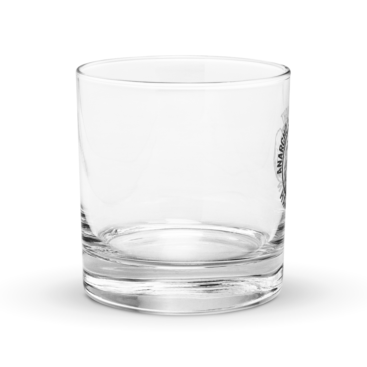 Anarcho Late Night Harlekin rocks glass, clear 10.5 oz whiskey glass with a round badge showing a grinning bear flexing its arm, an anarchy A on the biceps, the words ANARCHO LATE NIGHT arched above and HARLEKIN below, right side view with the badge at the right edge.