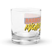 Michael Monday Anarcho Late Night rocks glass, clear 10.5 oz whiskey glass with a band running all the way around: ANARCHO LATE NIGHT in orange on grey above the name Michael Monday in yellow brush script, right side view showing ANARCHO and the start of the name.