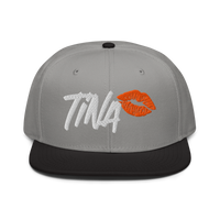TINA bitcoin snapback hat, front view: TINA embroidered in white brush lettering beside an orange lipstick kiss, on a snapback with a flat brim.