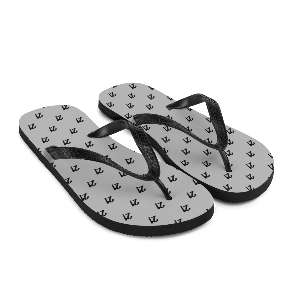 Side view of a pair of silver and black bitcoin flip flops.