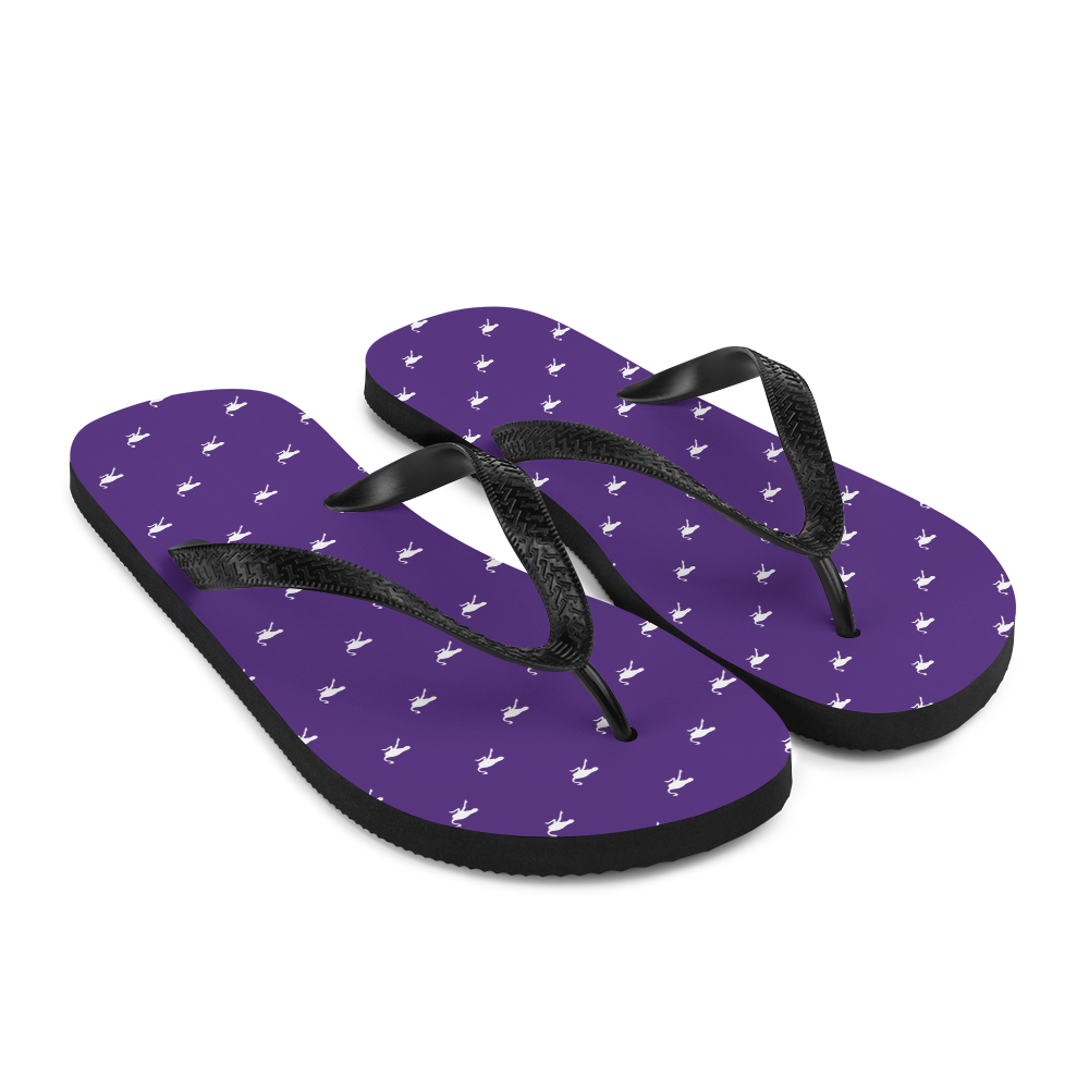 Side view of a pair of purple and black nostr flip flops.