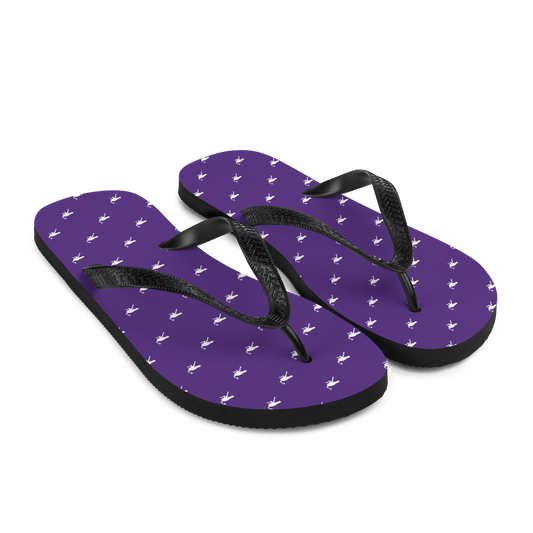 Side view of a pair of purple and black nostr flip flops.