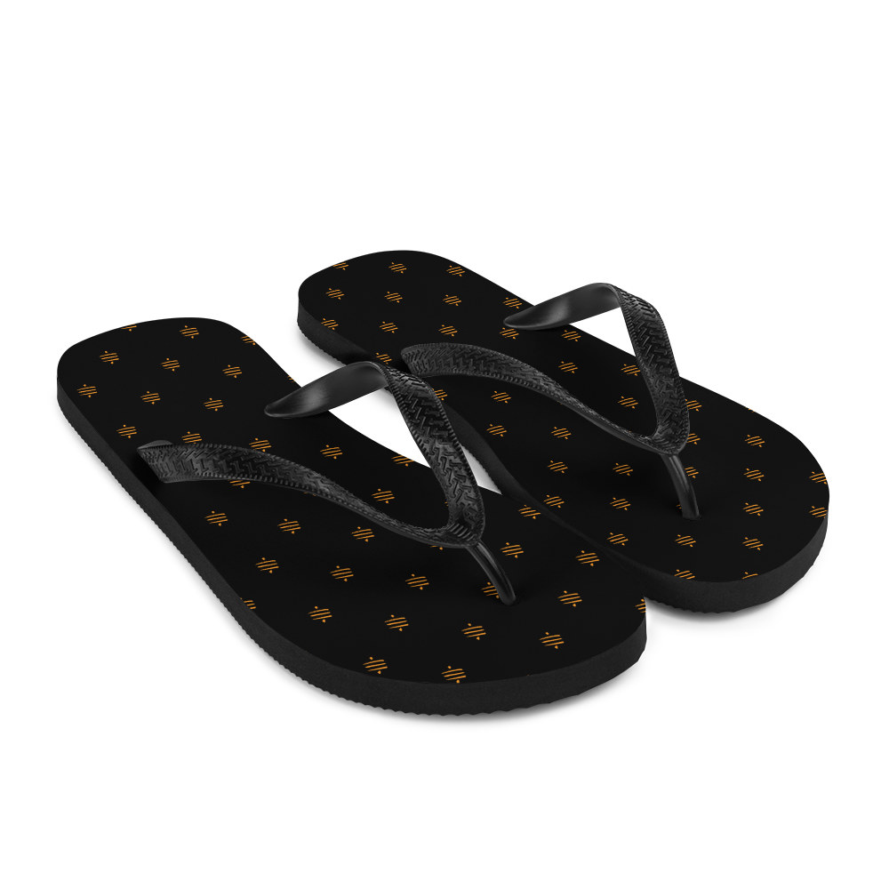 Side view of a pair of black bitcoin flip flops.