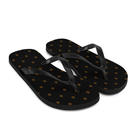 Side view of a pair of black bitcoin flip flops.