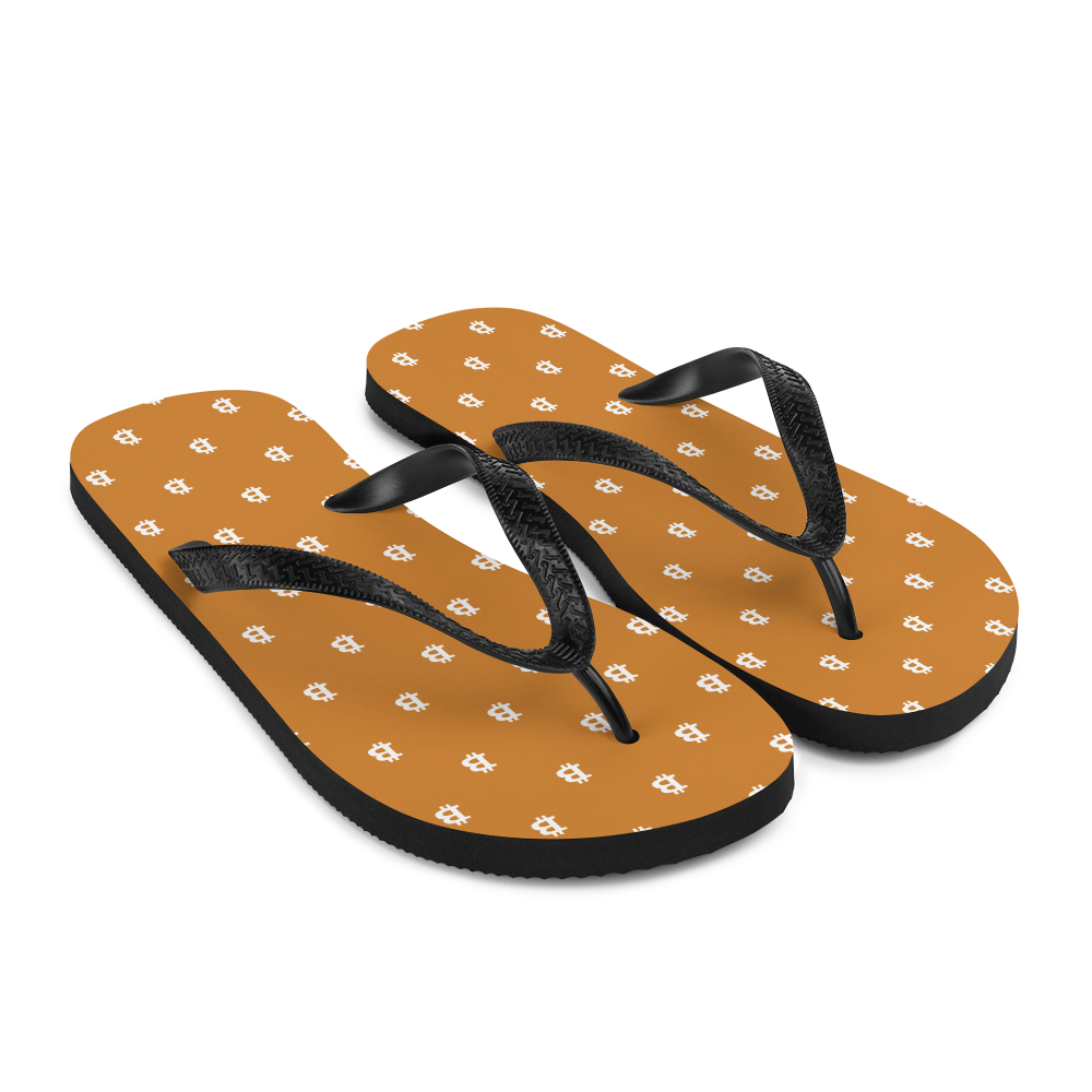 Side view of a pair of orange and black bitcoin flip flops.