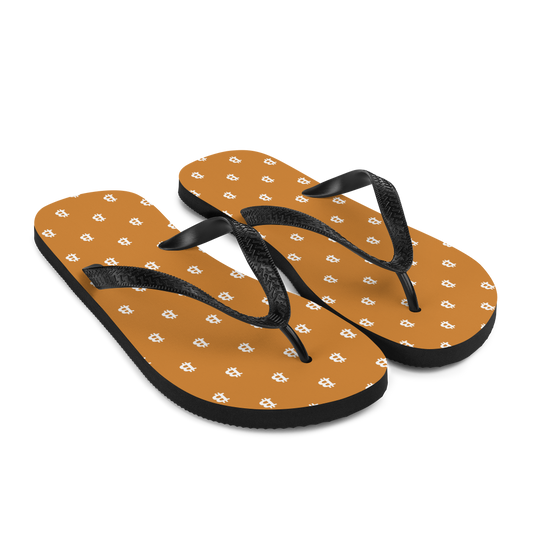 Side view of a pair of orange and black bitcoin flip flops.